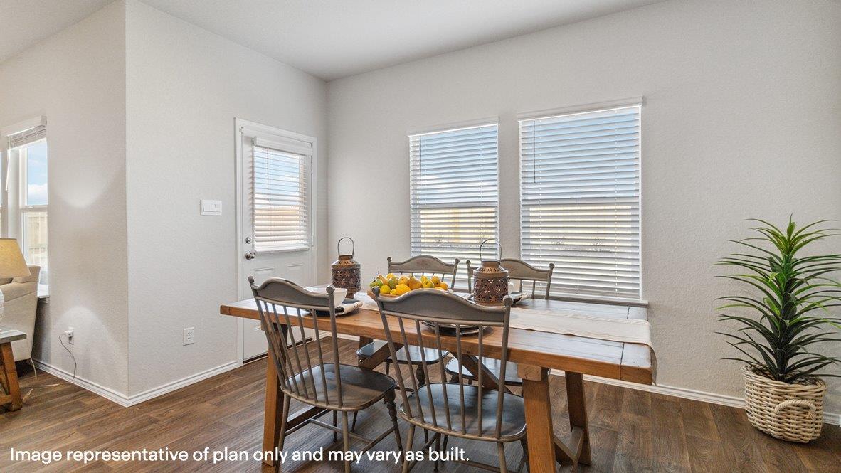 Open-concept dining area with hard surface flooring.