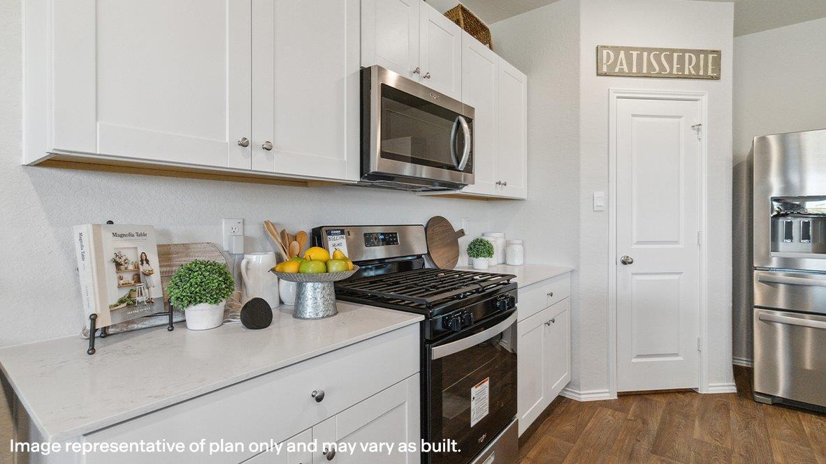 Spacious, open-concept kitchen with island, shaker style cabinets and granite or quartz countertops.