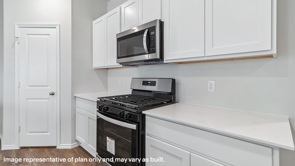 Open-concept kitchen with plenty of counterspace and spacious corner pantry.