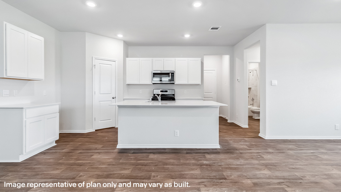 Open-concept kitchen with plenty of counterspace and spacious corner pantry.