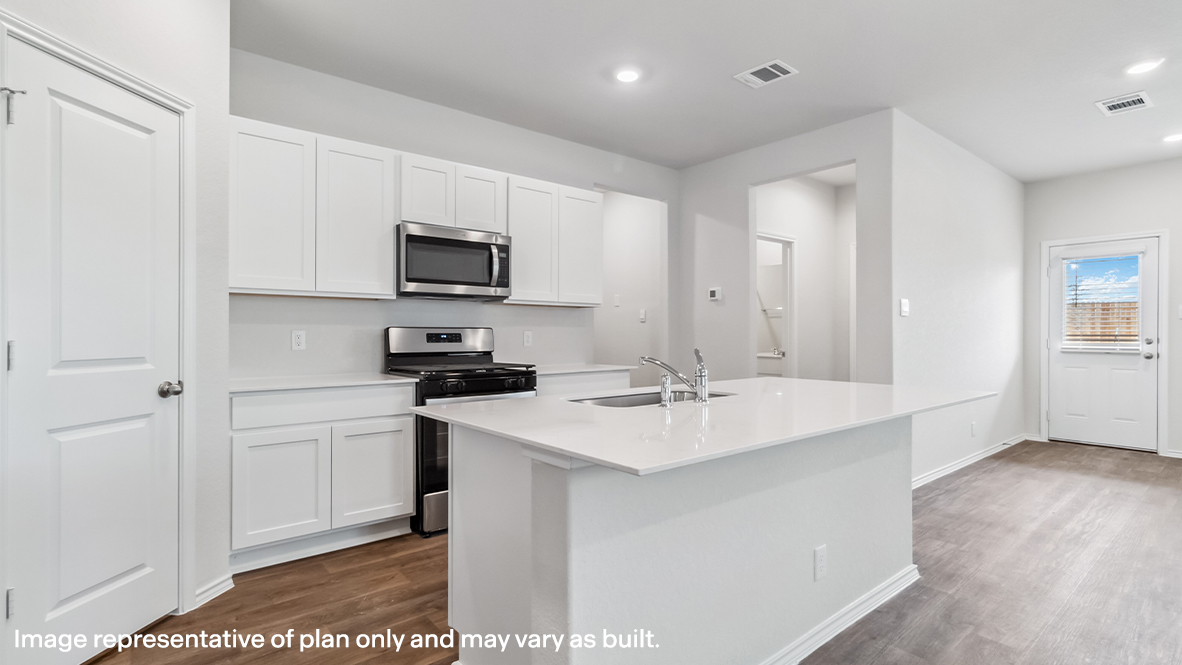 Spacious kitchen with stainless steel appliances and grand island.