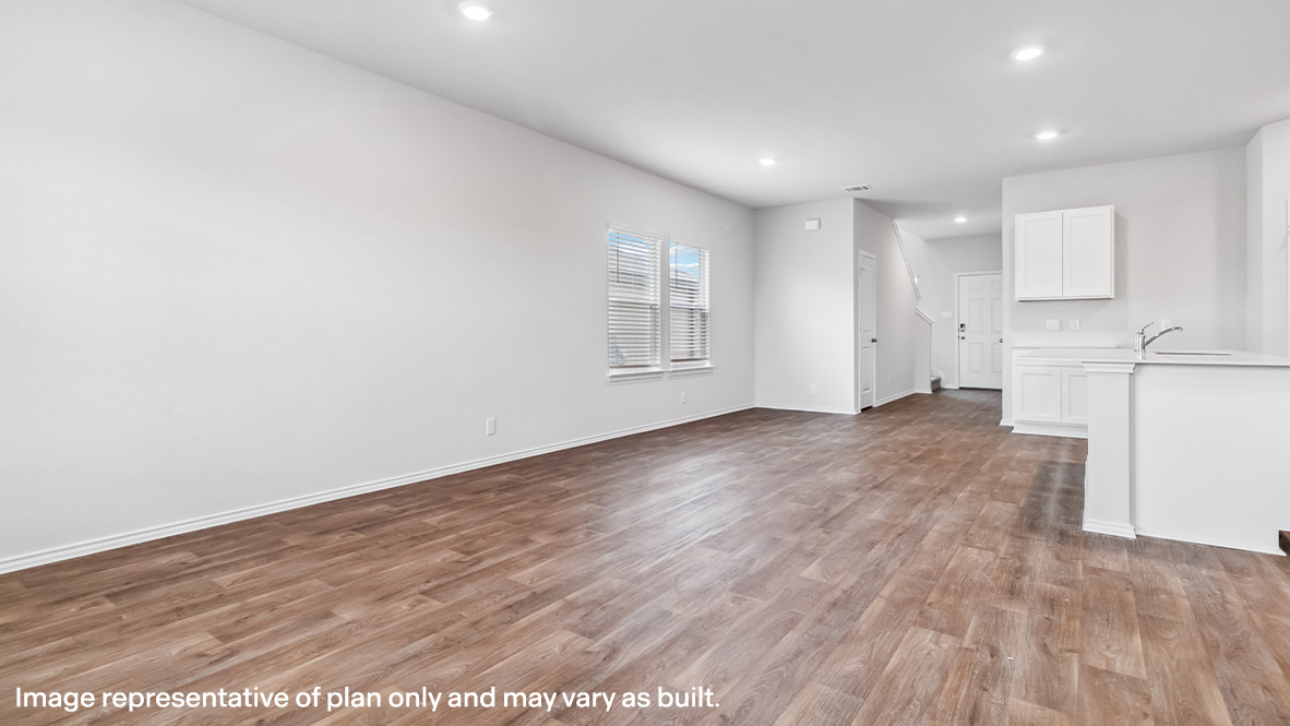 Open-concept living area with hard surface flooring and windows providing plenty of natural light.