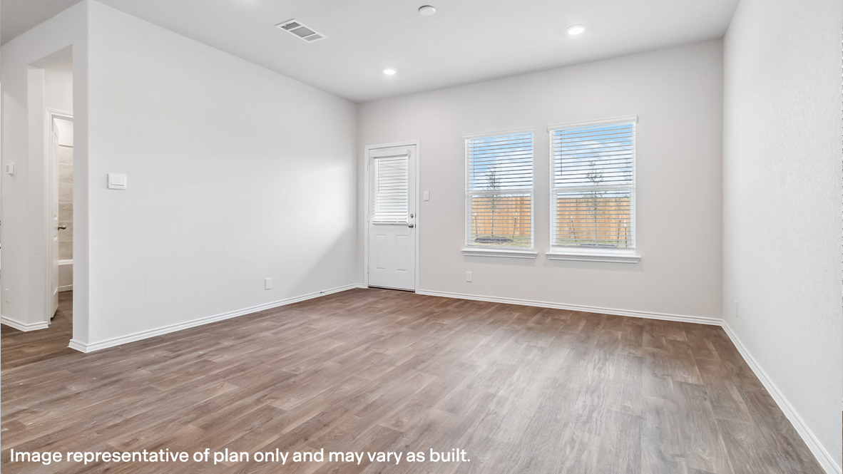 Living area with two windows and patio door.