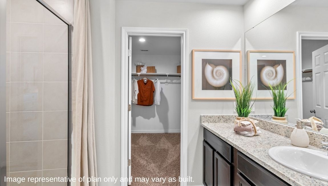 primary ensuite bathroom with walk in shower and walk in closet