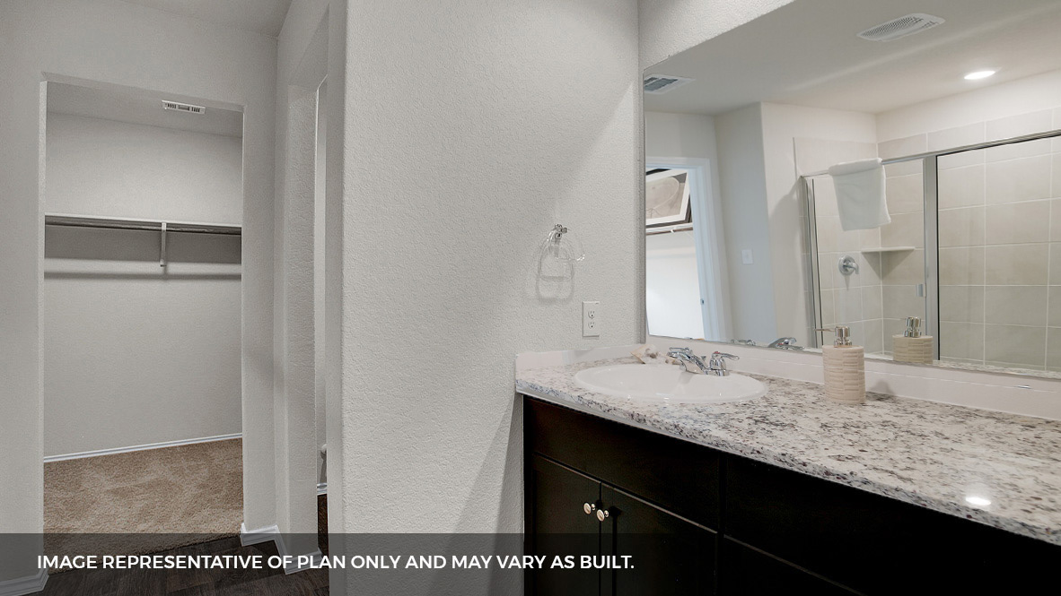 primary bathroom with walk in closet and walk in shower