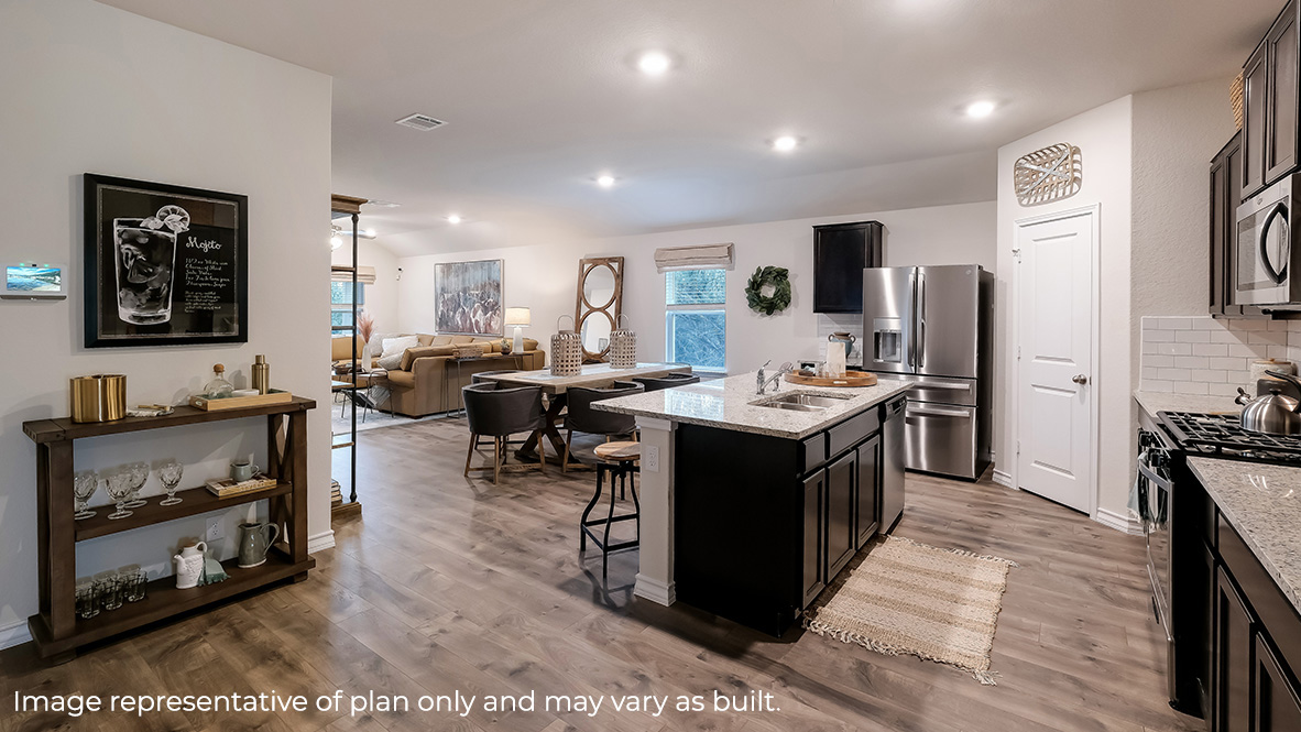 open concept kitchen flowing into dining area and living room
