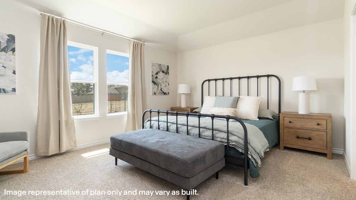 spacious primary bedroom with large windows and quality carpet