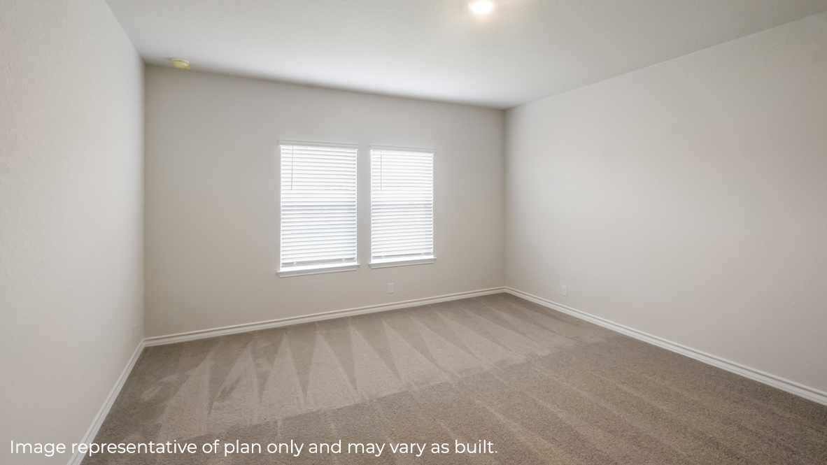 primary bedroom with large windows and carpet flooring