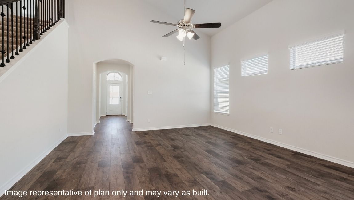 living room with tall ceilings, large windows and hard surface flooring.