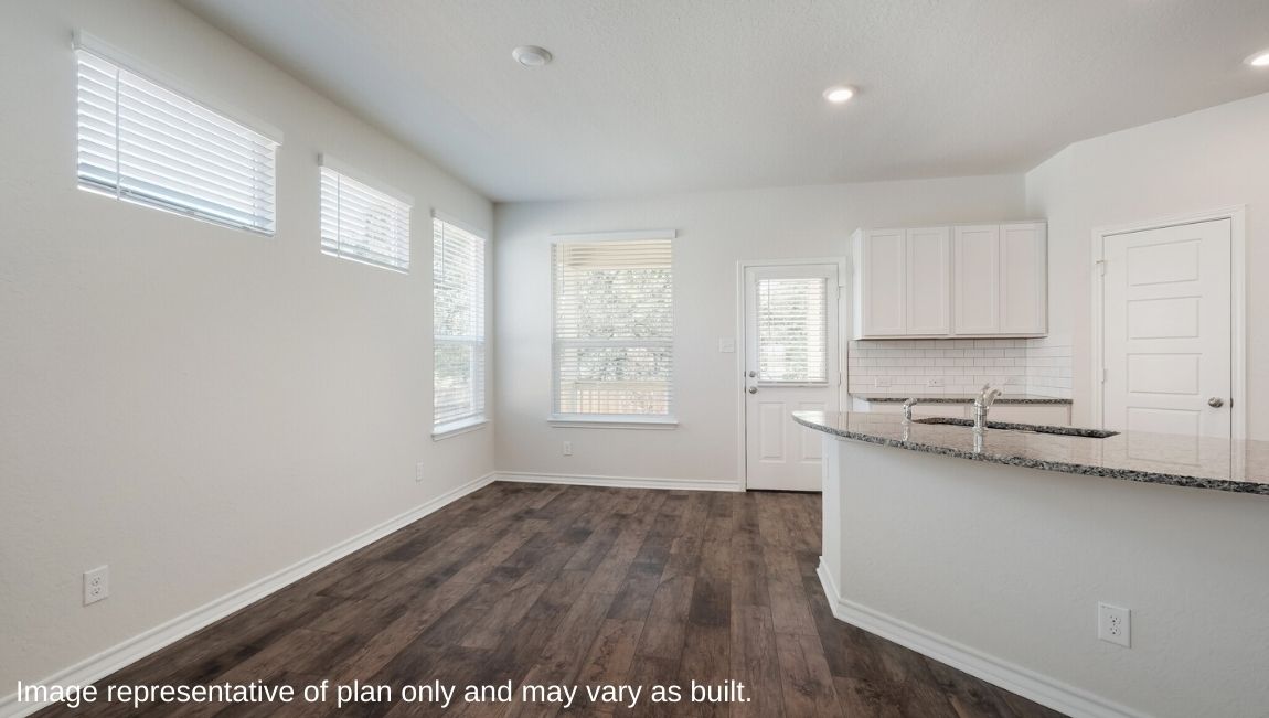 Dining area with hard surface flooring, large windows and door leading to covered patio (per plan).