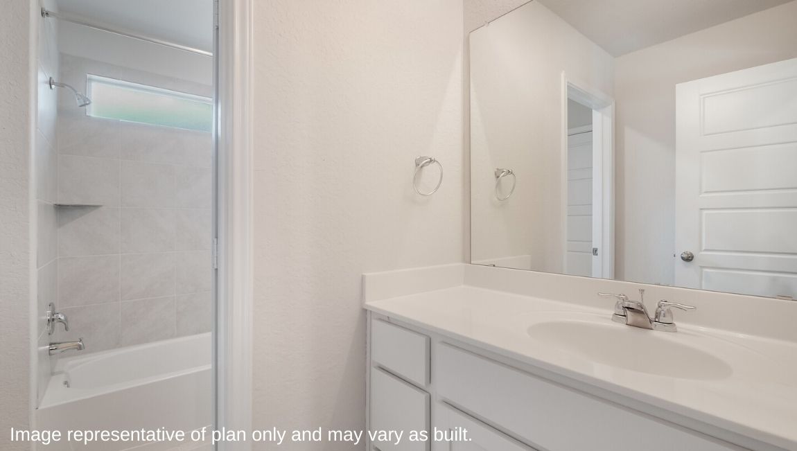 Second full bathroom with single vanity sink and separate space for toilet and combined tub and shower.