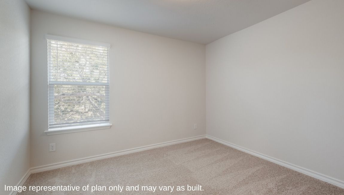 Fourth bedroom with carpet flooring and large window.