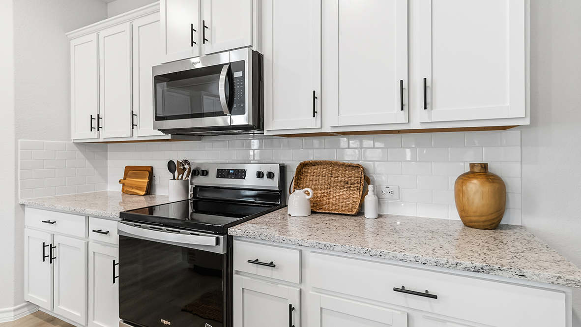 kitchen with stainless steel appliances and subway tile backsplash