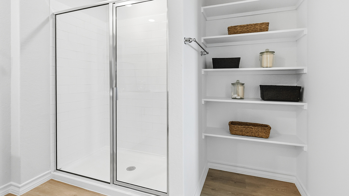 primary ensuite bathroom with walk in shower and built in shelving