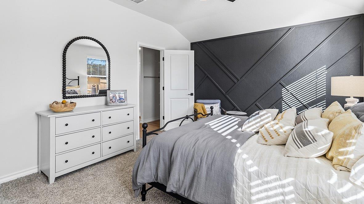 primary bedroom suite with accent wall