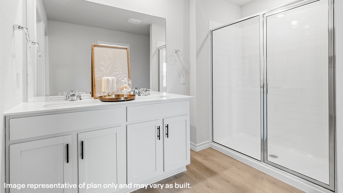 ensuite bathroom with dual vanity sinks and walk in shower