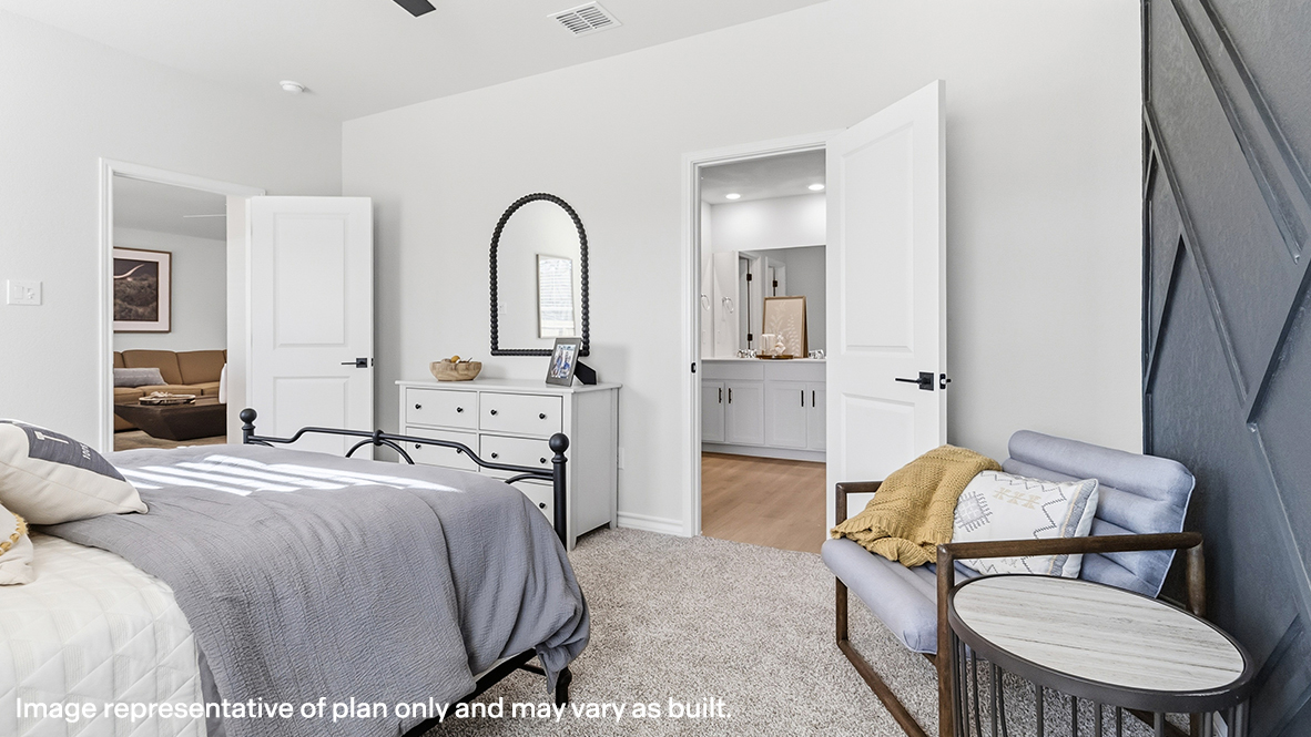 primary bedroom suite with accent wall and ensuite bathroom
