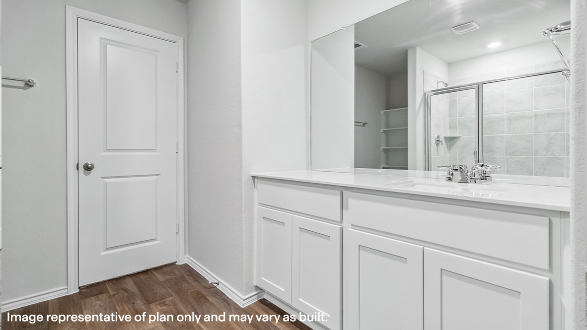 Spacious primary bathroom with plenty of counterspace, single vanity sink and hard surface flooring.