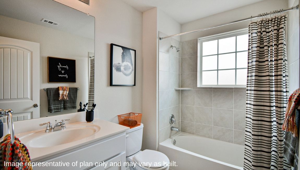 Second full bathroom with combined bathtub and shower, toilet and hard surface flooring.