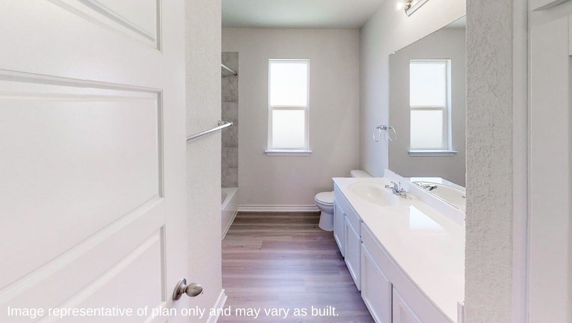 primary bathroom with hard surface flooring and double vanity sinks