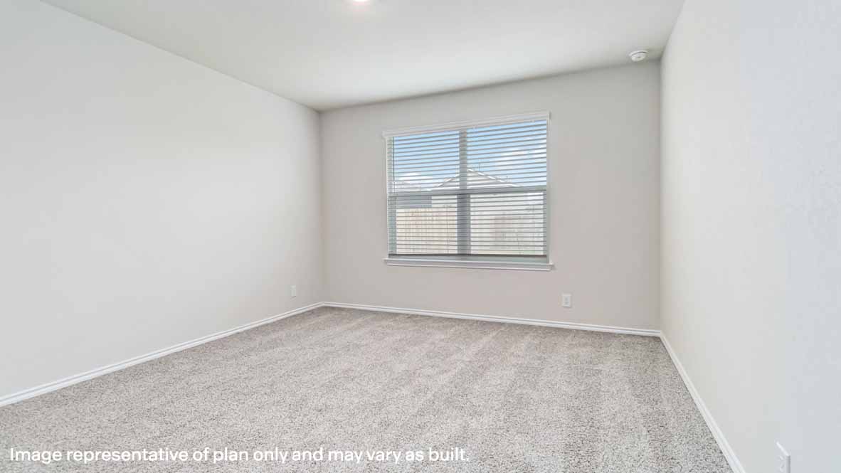 spacious primary bedroom with quality carpet and window