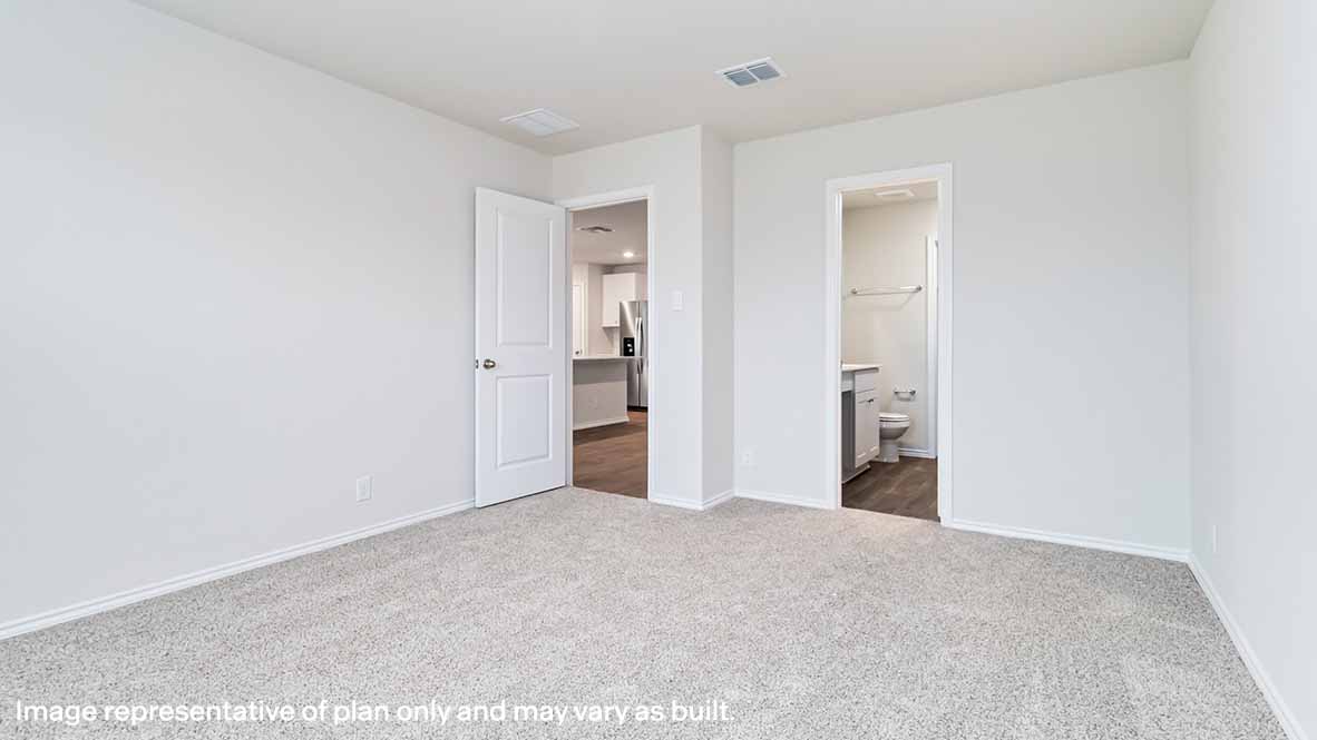 spacious primary bedroom with quality carpet and window