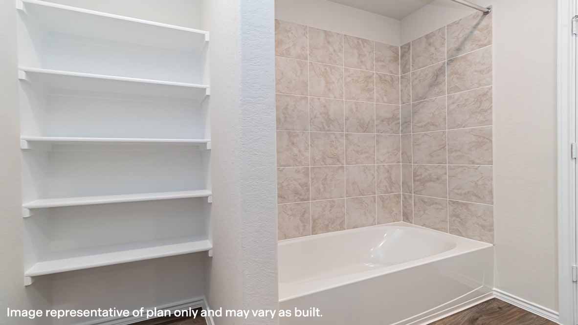 spacious primary bathroom with combined shower and tub combo and built in shelving