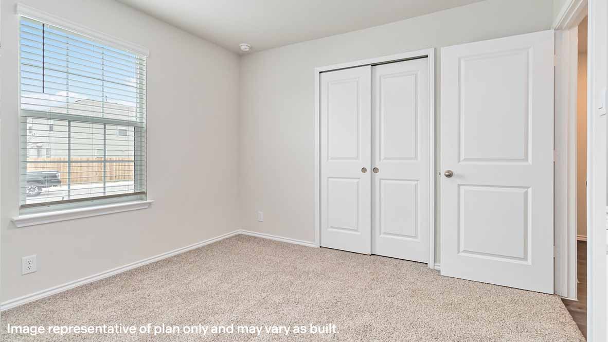 spacious secondary bedroom with quality carpet and window