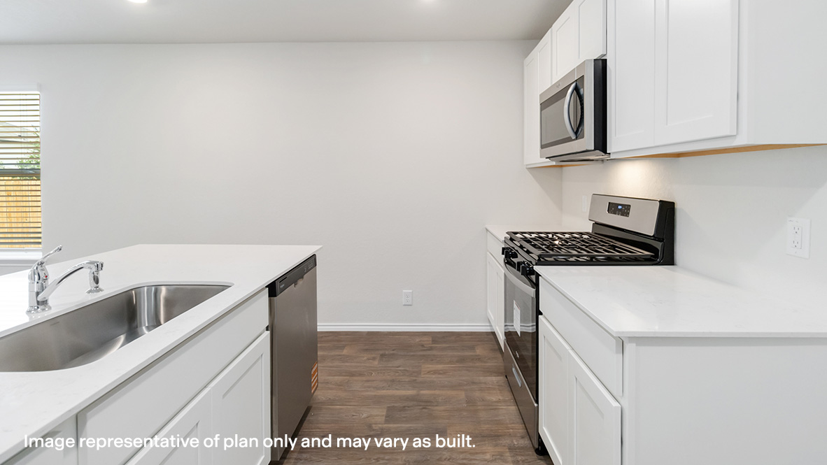 kitchen with quartz countertops and kitchen island with farmhouse style sink.