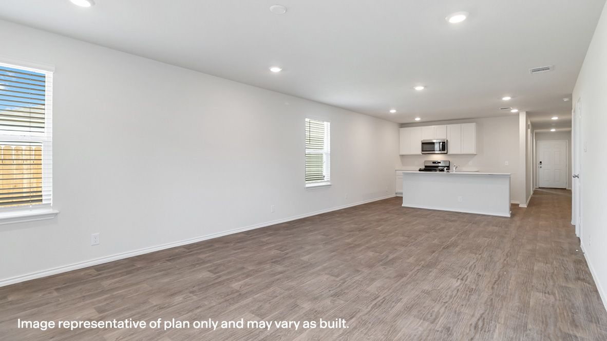 Living space, dining area and kitchen arranged in an open concept layout.