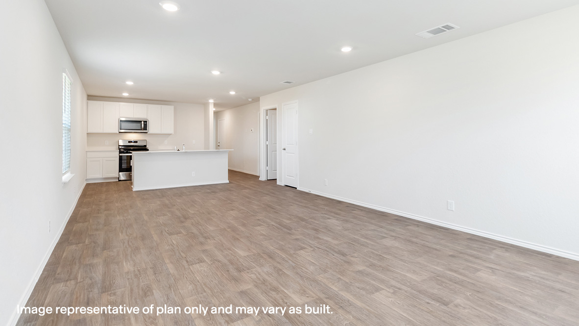 Living space, dining area and kitchen arranged in an open concept layout.