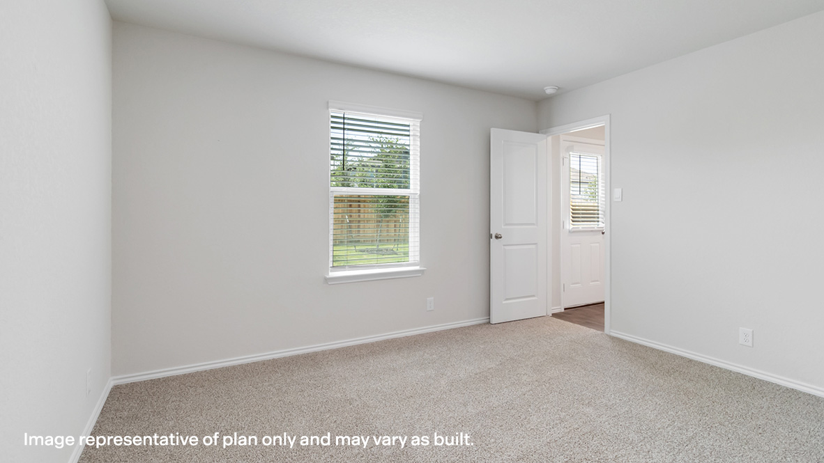 Primary bedroom with carpet flooring and large window.