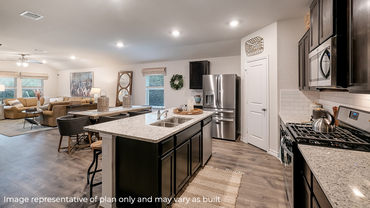 kitchen with quartz or granite countertops, classic subway tile backsplash, stainless steel appliances and kitchen island overlooking blended dining area and living room.