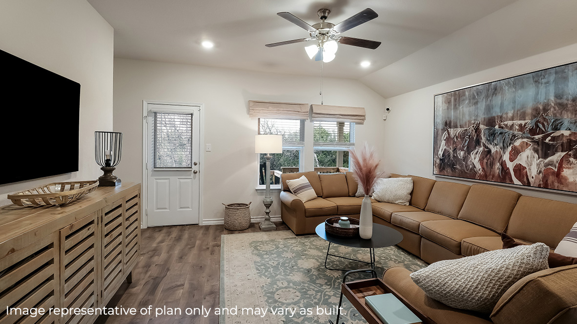 living room with hard surface flooring, large windows and dooway leading to fully landscaped backyard.