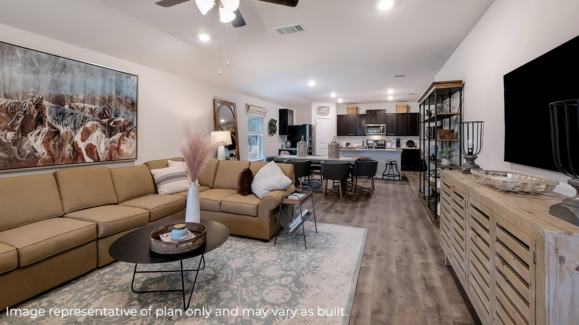 open concept living room flowing to dining area and kitchen with hard surface flooring throughout.