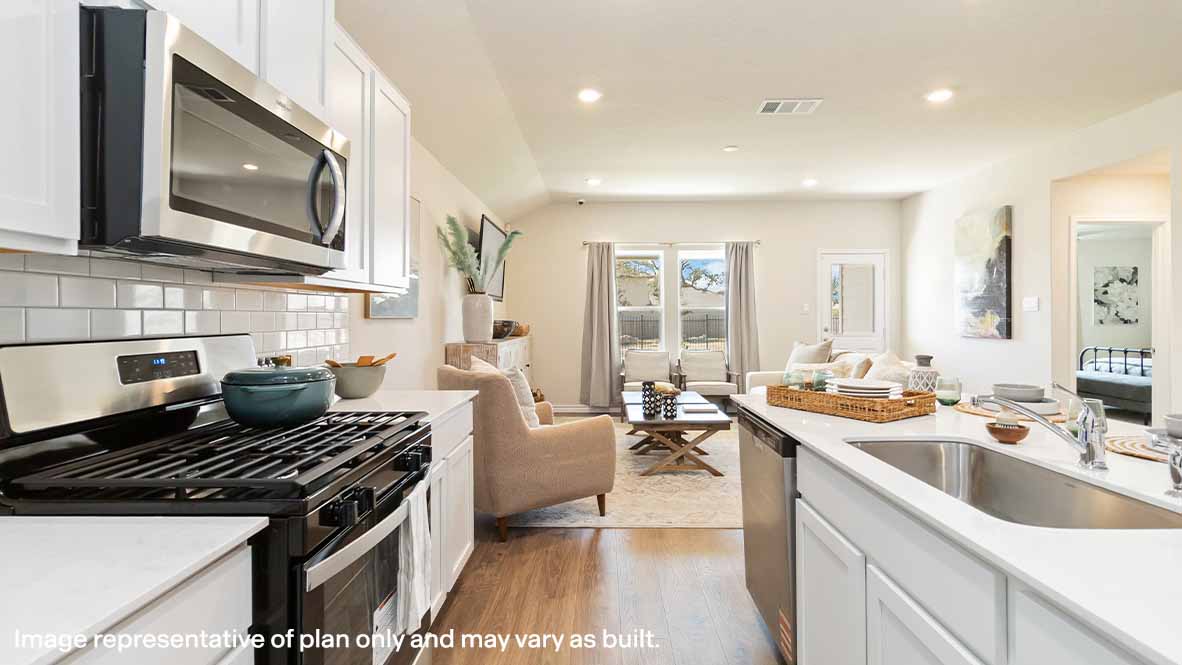 spacious kitchen with stainless steel appliances and classic white subway tile backsplash