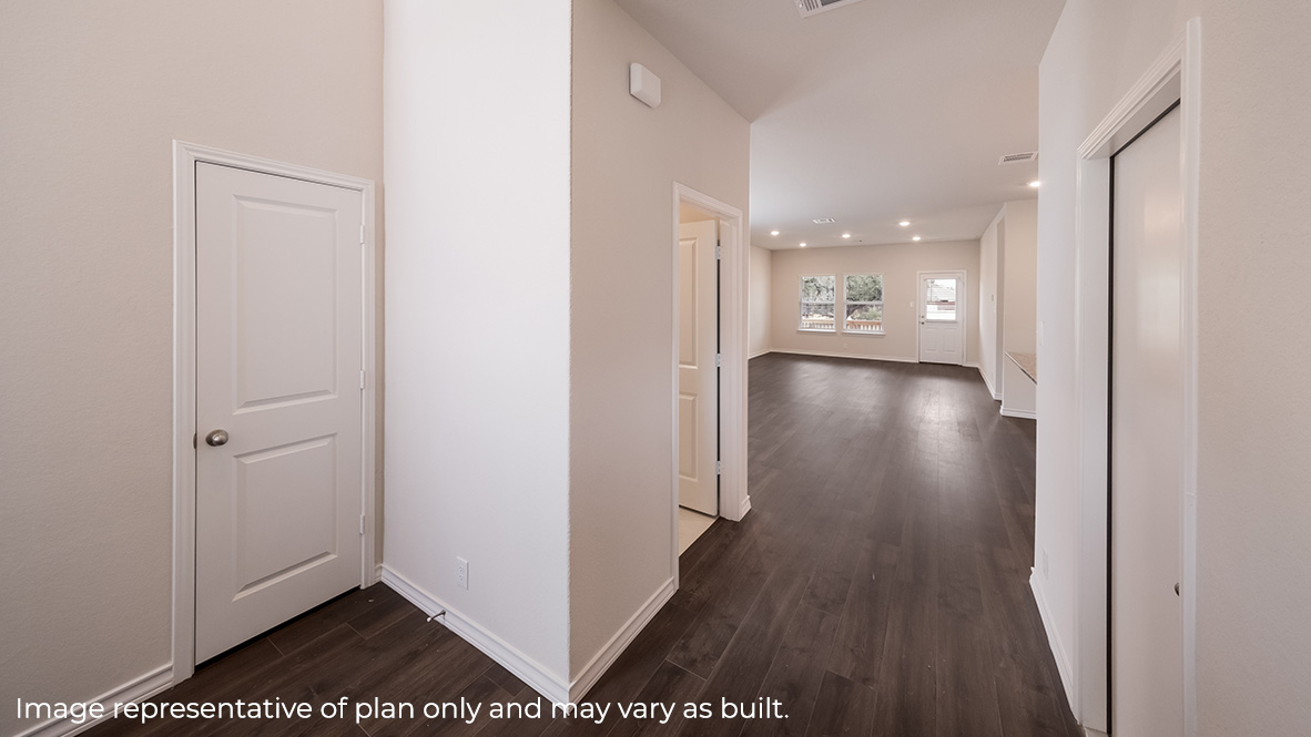 entry hall of the home flowing into open concept kitchen, living room and dining area.