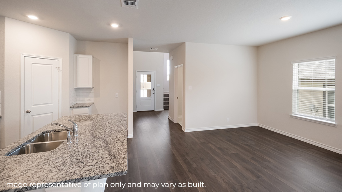 kitchen island with granite or quartz countertop overlooking dining space.