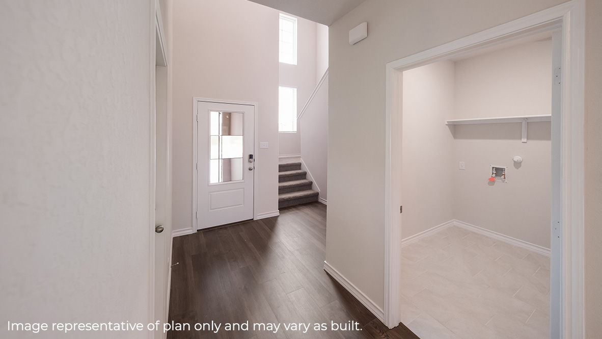 Entryway with wood flooring and entrance to the laundry room