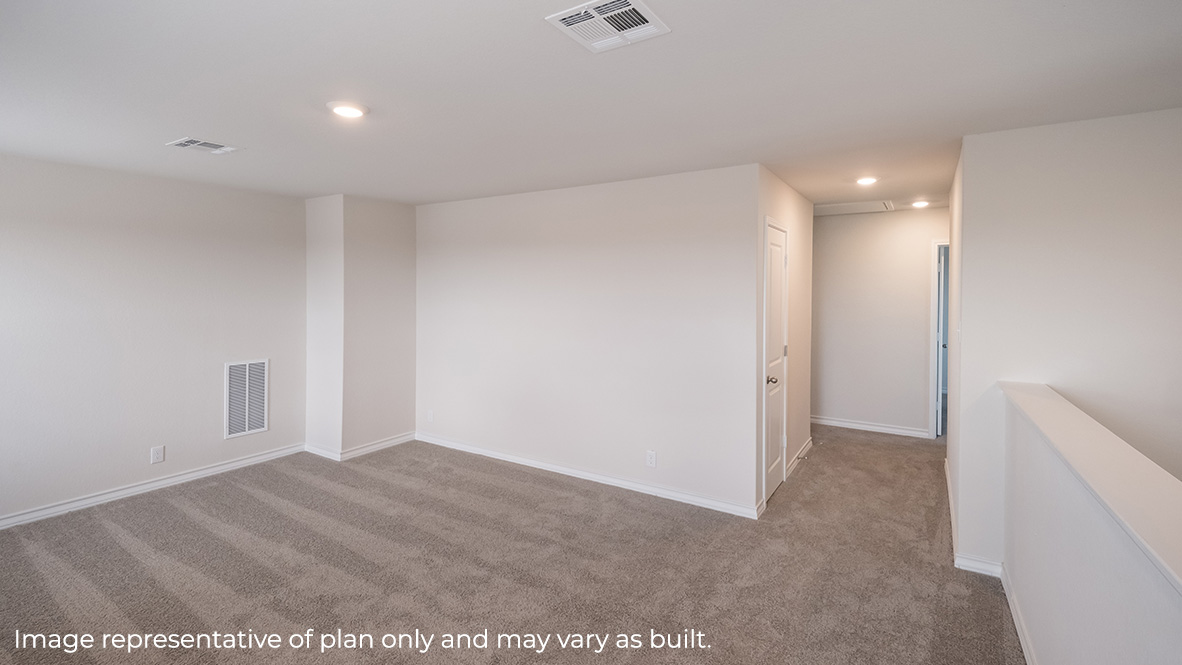 Large loft area with carpet and a hallway leading to bedrooms