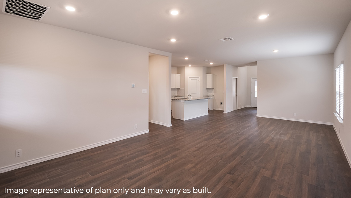 open concept living room, dining area and kitchen with hard surface flooring throughout.