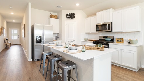 kitchen with stainless steel appliances and large kitchen island overlooking dining space