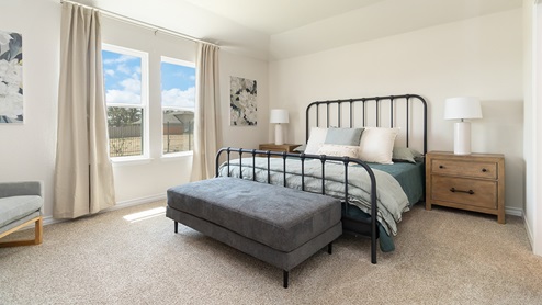 primary bedroom with quality carpet flooring and large windows