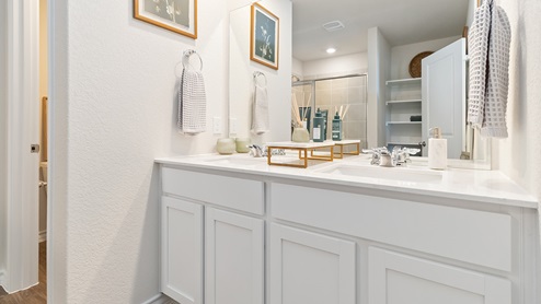 primary ensuite bathroom with dual vanity sinks