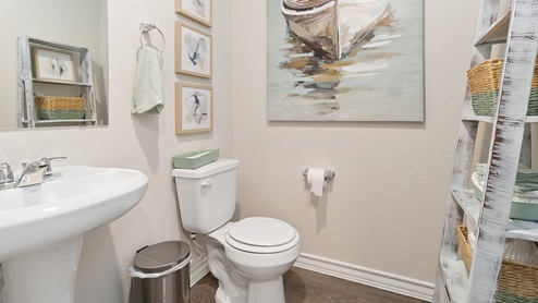 powder bathroom with pedestal sink and toilet