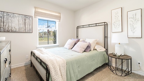 secondary bedroom with large windows and quality carpet flooring