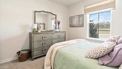secondary bedroom with large windows and quality carpet flooring