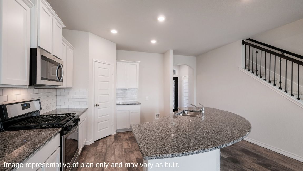 Other side view of kitchen with pantry, cabinets near stairs, dining and living areas Brookstone Creek