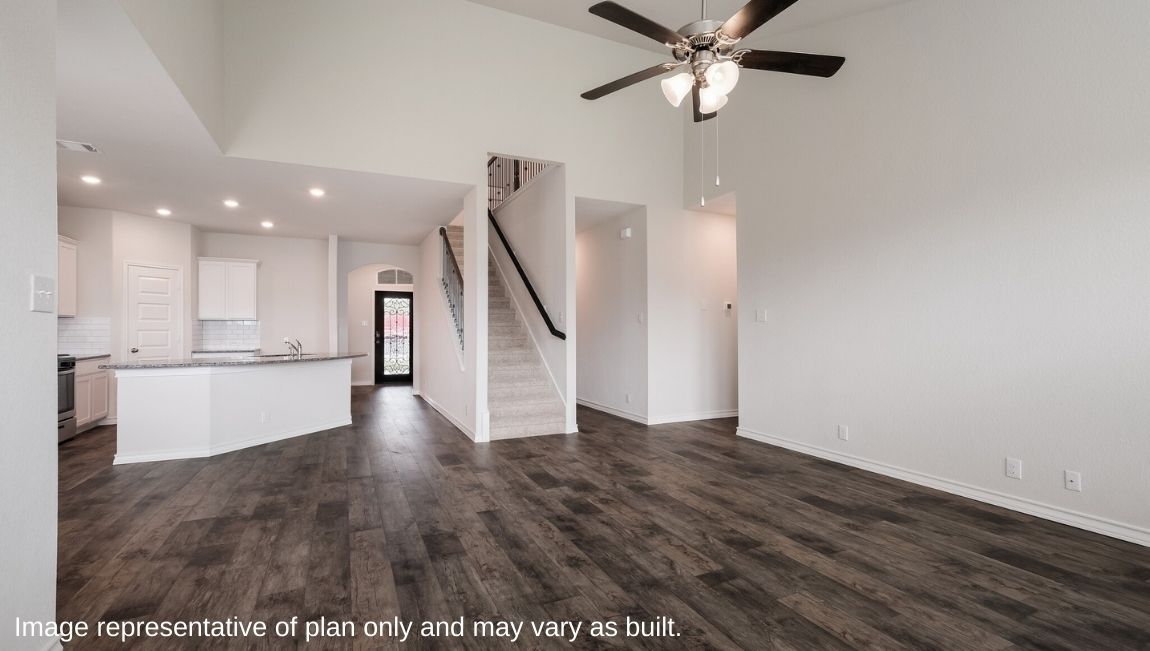 Living room looking to dining and kitchen areas in this new home features natural light, with fresh open concept flow