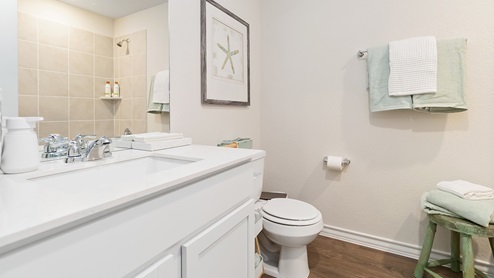 second full bathroom with single vanity sink, toilet and tub and shower combo